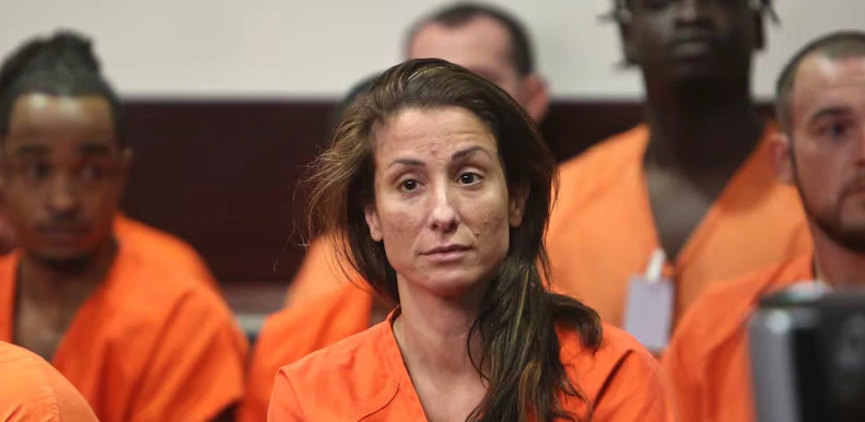 Teacher Stephanie Ragusa sits in a jail uniform with other inmates